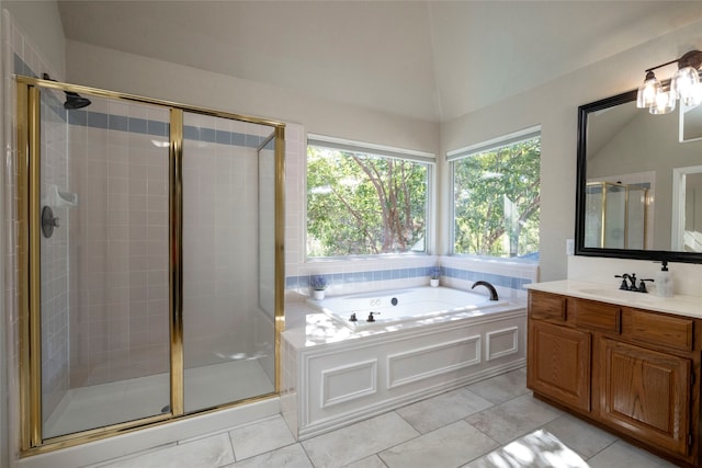 bathroom featuring separate shower and tub, vanity, and vaulted ceiling