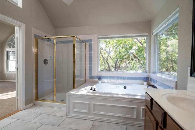 bathroom featuring plus walk in shower, vanity, and lofted ceiling