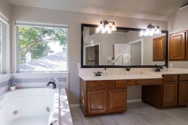 bathroom featuring vanity, a bath, and an inviting chandelier