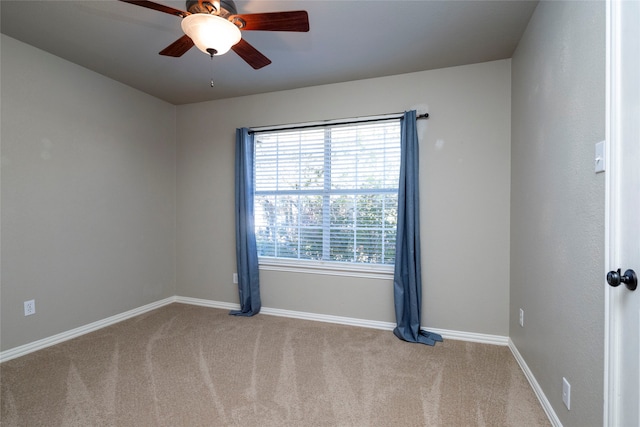 unfurnished room with ceiling fan and light colored carpet