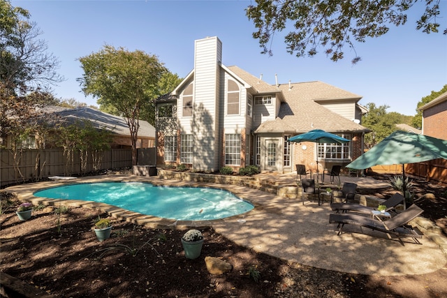 view of pool featuring a diving board and a patio area