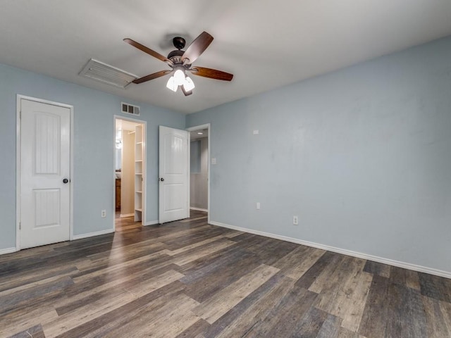 unfurnished bedroom with ceiling fan and dark hardwood / wood-style floors