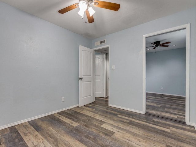 unfurnished room featuring dark wood-type flooring