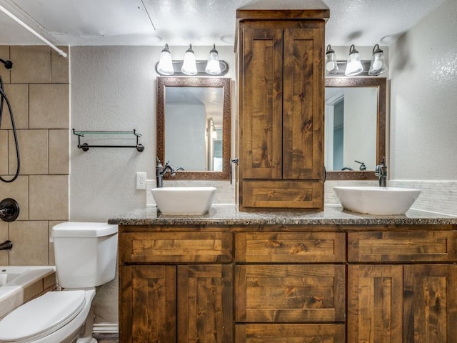 full bathroom with vanity, toilet, and tiled shower / bath