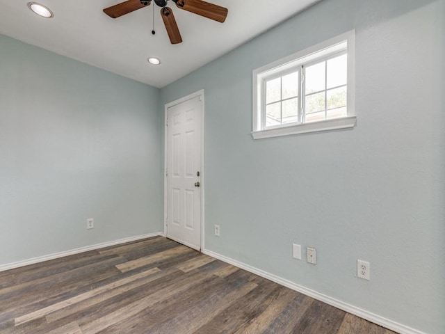 spare room featuring ceiling fan and dark hardwood / wood-style floors