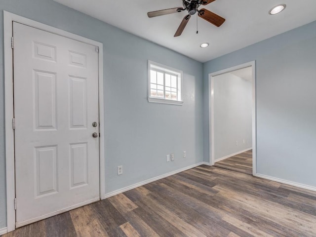 empty room featuring ceiling fan and dark hardwood / wood-style flooring