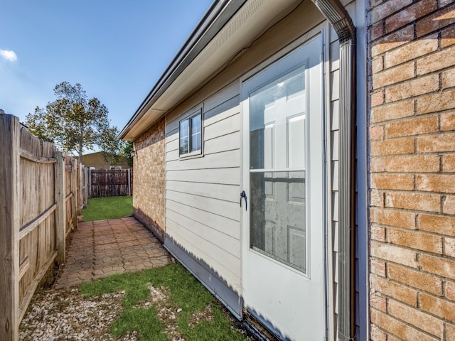 view of property exterior with a patio area