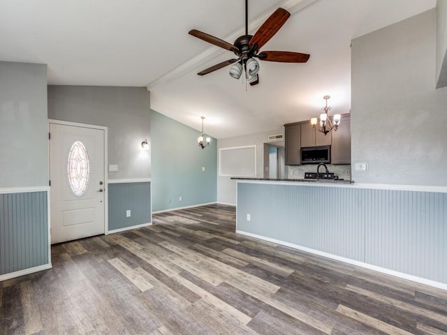 interior space featuring sink, vaulted ceiling with beams, dark hardwood / wood-style flooring, and ceiling fan with notable chandelier