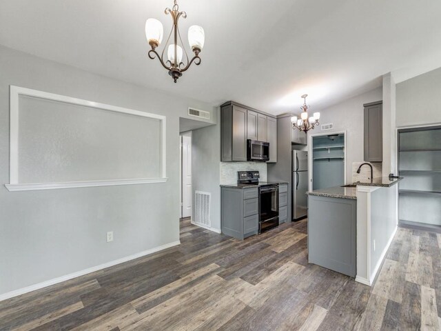 kitchen with decorative light fixtures, gray cabinets, appliances with stainless steel finishes, and a chandelier