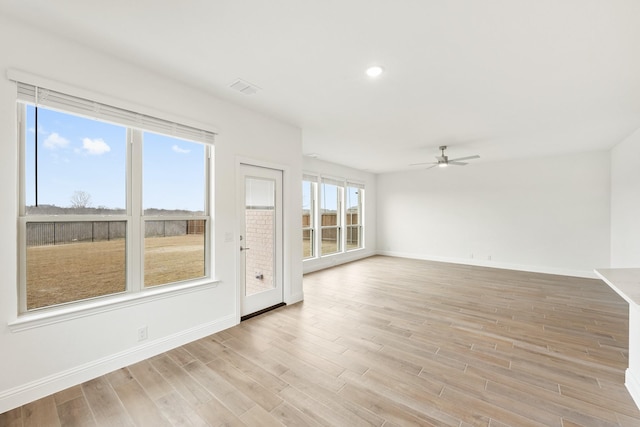 spare room with light hardwood / wood-style floors and ceiling fan