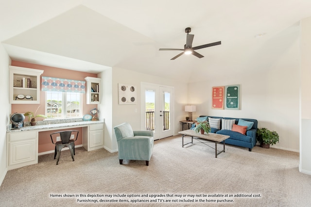 living room featuring built in desk, light carpet, and plenty of natural light