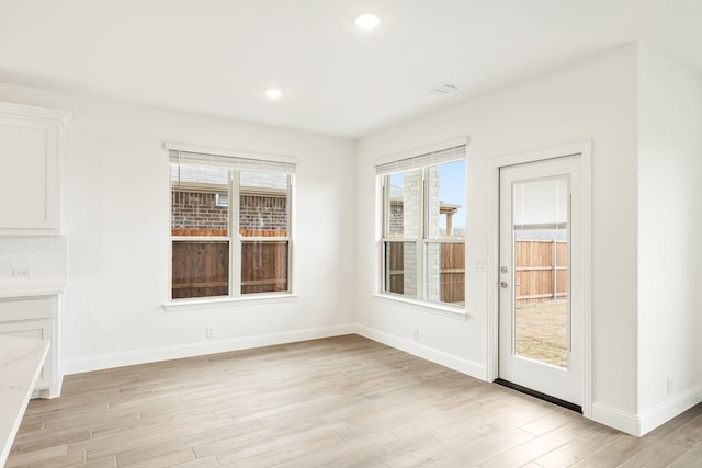 spare room with light hardwood / wood-style flooring