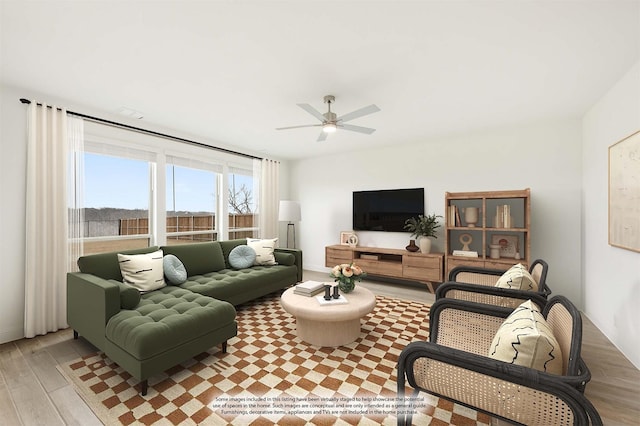 living room with ceiling fan and light wood-type flooring