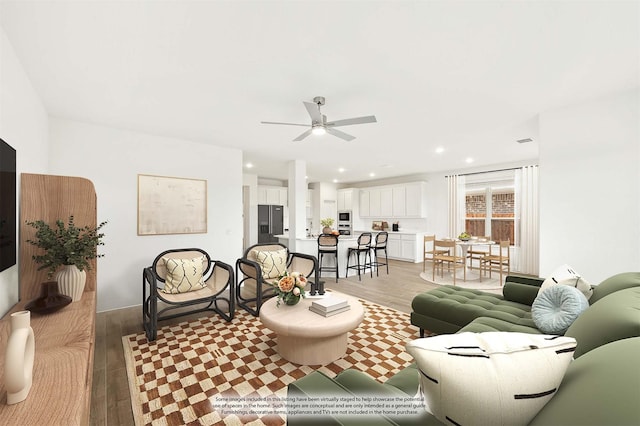 living room featuring ceiling fan and light wood-type flooring