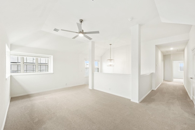 empty room featuring light carpet, lofted ceiling, and ceiling fan