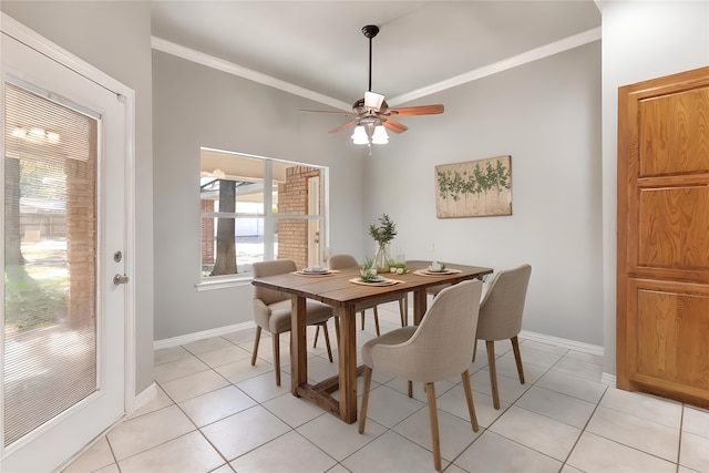 dining room featuring crown molding, light tile patterned floors, and ceiling fan