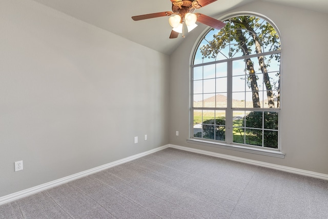 spare room with ceiling fan, carpet, and vaulted ceiling