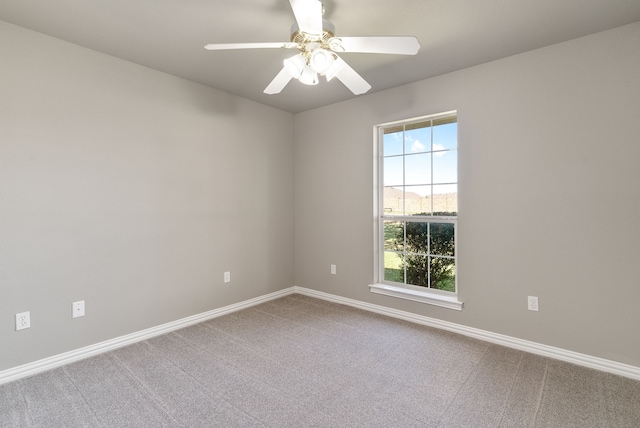 empty room featuring carpet flooring and ceiling fan