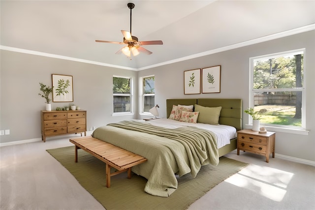 carpeted bedroom featuring ceiling fan, ornamental molding, and vaulted ceiling