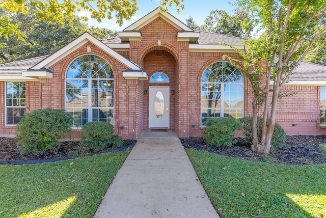 property entrance with a yard