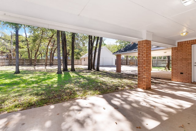 view of patio / terrace featuring an outbuilding and a garage