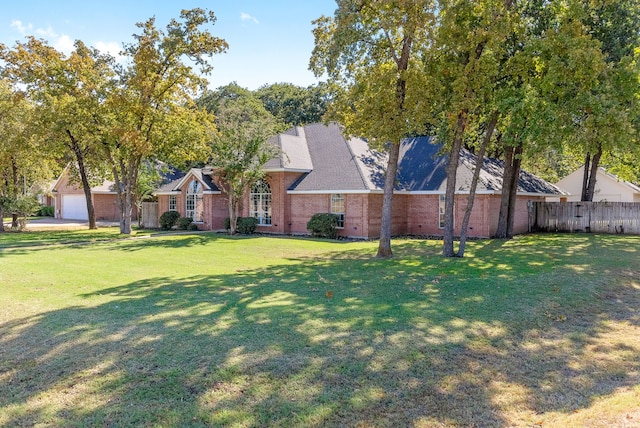 view of front of property featuring a front yard and a garage