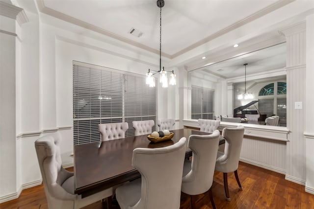 dining room featuring an inviting chandelier, dark wood-type flooring, and crown molding