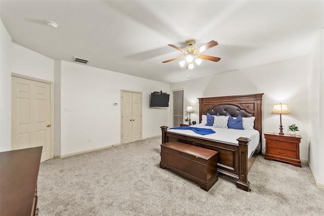 bedroom with ceiling fan and light colored carpet