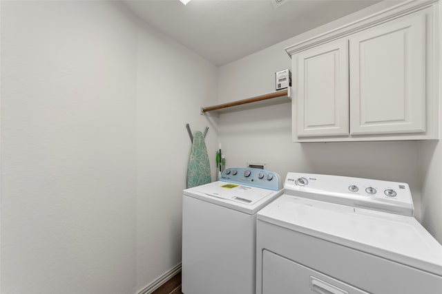 laundry area featuring cabinets and washing machine and dryer