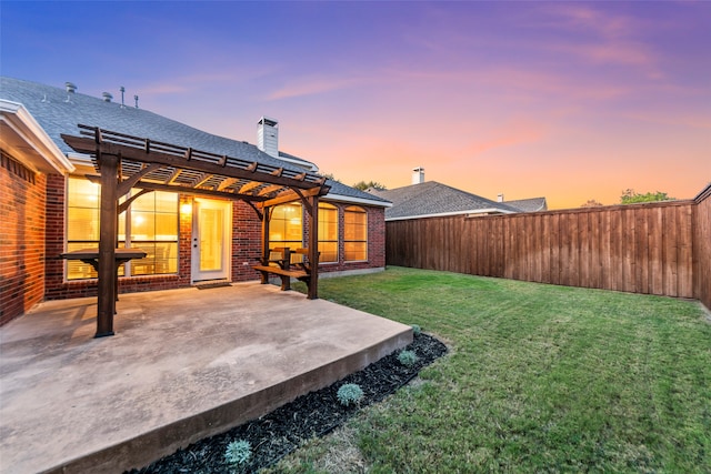 yard at dusk featuring a pergola and a patio