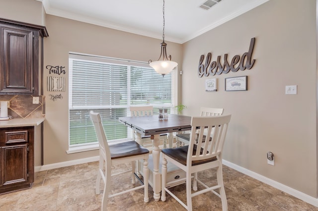 dining area featuring crown molding