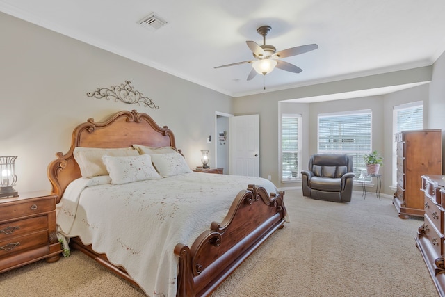 bedroom with ornamental molding, ceiling fan, and carpet flooring