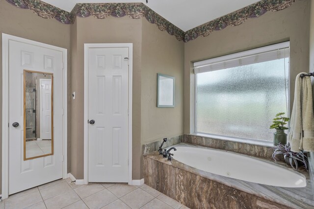 8525 Castle Creek Rd, North Richland Hills, TX 76182 - bathroom with tile patterned floors and a bath