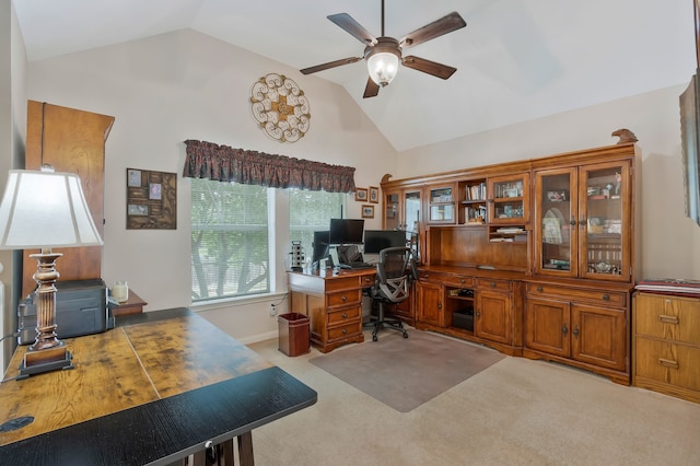 office space featuring vaulted ceiling, ceiling fan, and light carpet