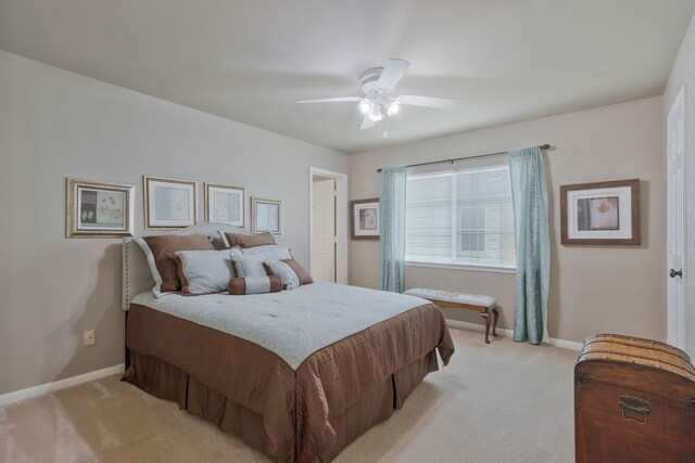 bedroom featuring ceiling fan and light colored carpet