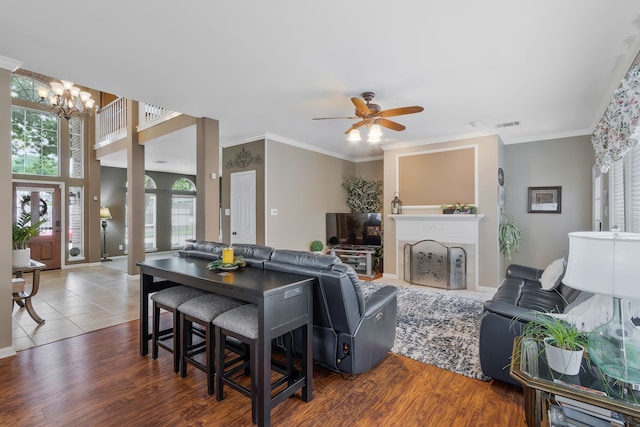 8525 Castle Creek Rd, North Richland Hills, TX 76182 - living area with a chandelier, a ceiling fan, a fireplace, ornamental molding, and wood finished floors