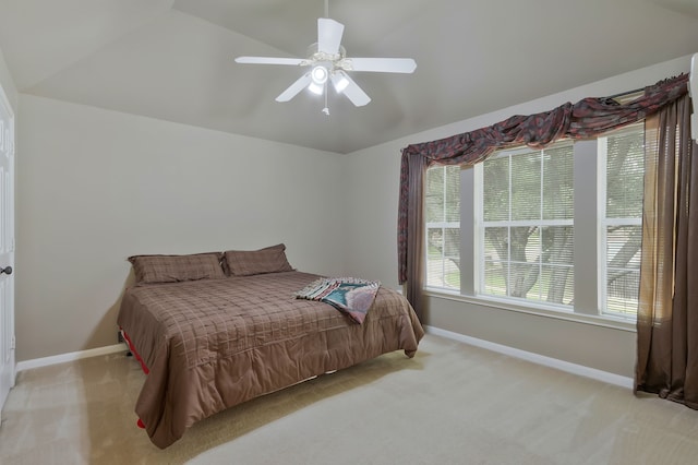 bedroom featuring ceiling fan, lofted ceiling, and light carpet