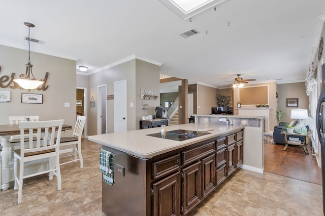 8525 Castle Creek Rd, North Richland Hills, TX 76182 - kitchen with black electric stovetop, crown molding, light countertops, open floor plan, and a ceiling fan