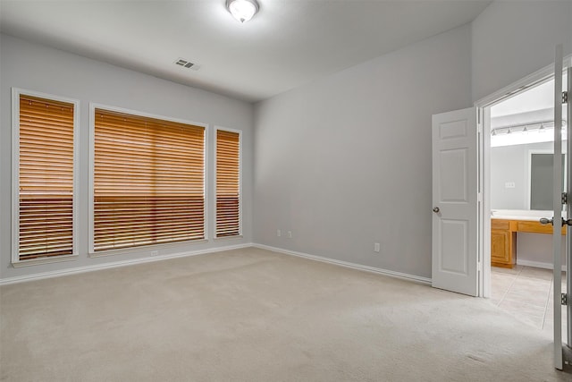 unfurnished room featuring light colored carpet