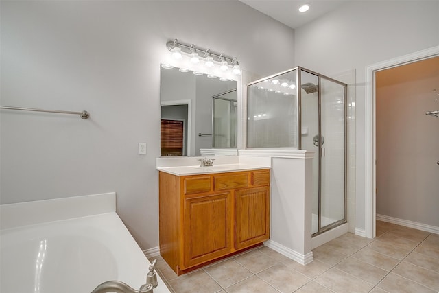 bathroom featuring vanity, plus walk in shower, and tile patterned flooring