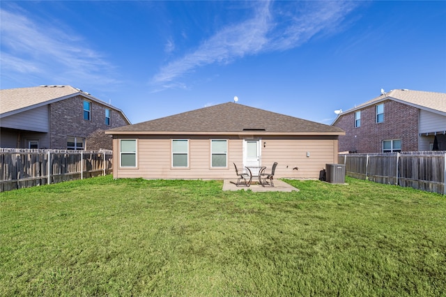 rear view of property featuring a patio, central AC, and a lawn