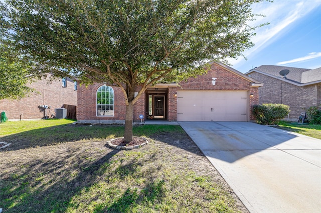 view of front of property with a front yard, central AC, and a garage