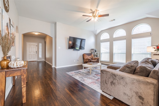 living room with ceiling fan, dark hardwood / wood-style flooring, a healthy amount of sunlight, and lofted ceiling