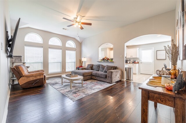 living room featuring hardwood / wood-style floors, vaulted ceiling, and ceiling fan