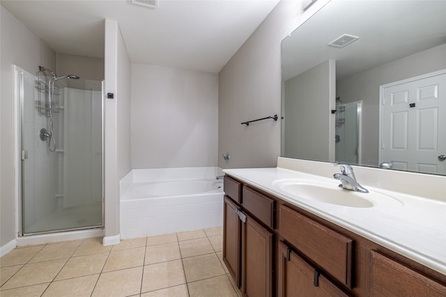 bathroom featuring tile patterned flooring, vanity, and separate shower and tub