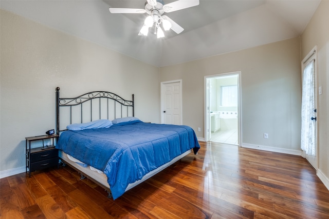 bedroom featuring dark hardwood / wood-style floors, ensuite bath, ceiling fan, and lofted ceiling