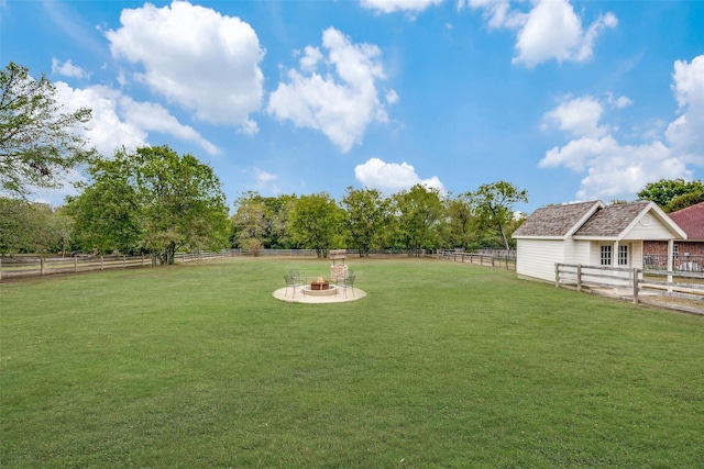 view of yard with a rural view and a fire pit