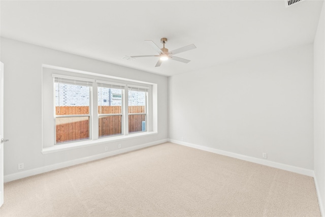 empty room featuring carpet flooring and ceiling fan