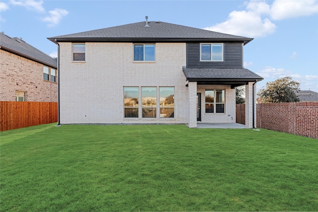 back of house with a yard and a patio