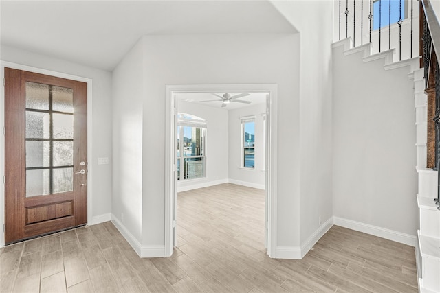 foyer entrance with ceiling fan